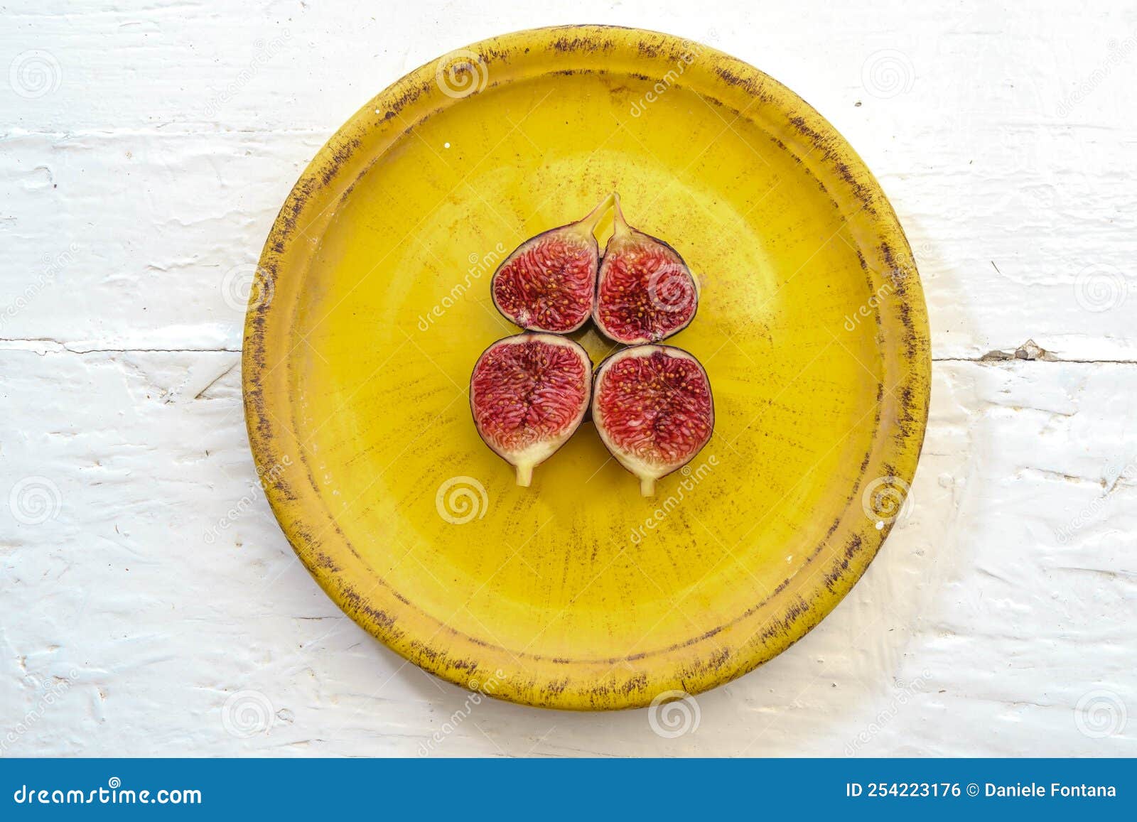 seasonal fruits dark sardinian figs on a vintage yellow plate