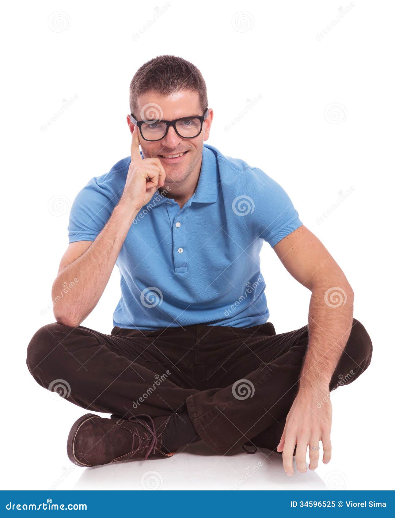 Seated Casual Man Smiles With Hand On Cheek Royalty Free 