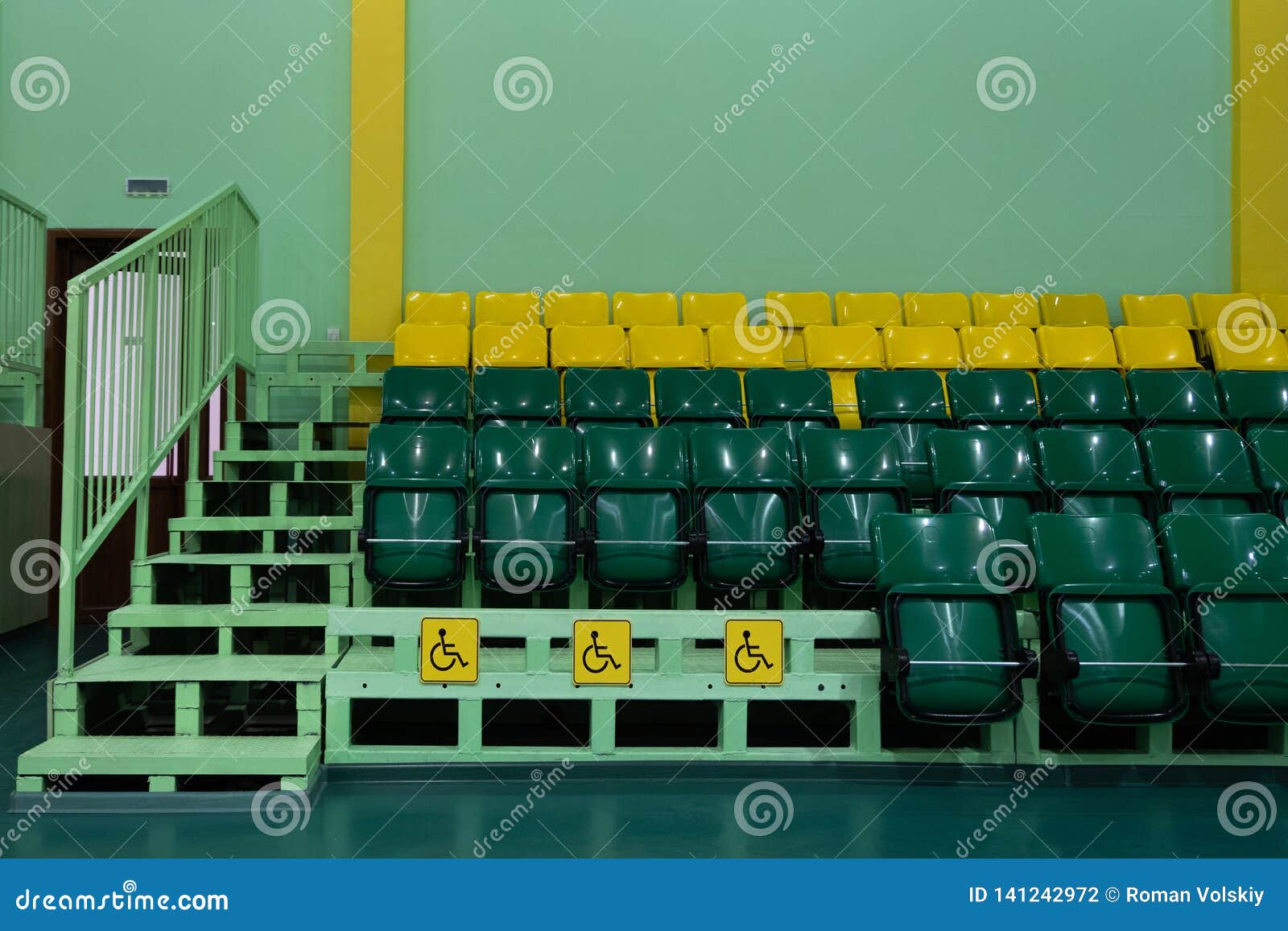 seating seats sports hall. green and yellow seats and seats for the disabled. copy space. territory without people
