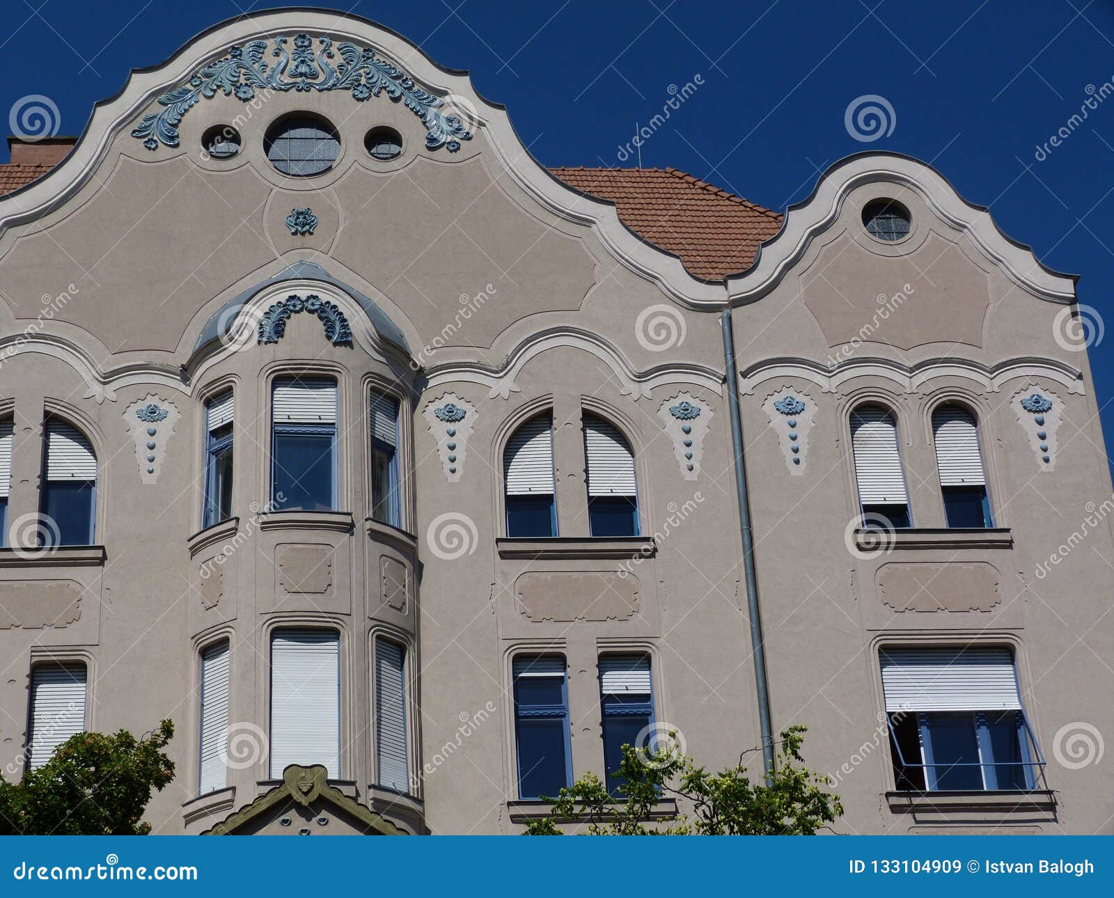 secessionist style facade detail with balcony and white windows in szeged, hungary