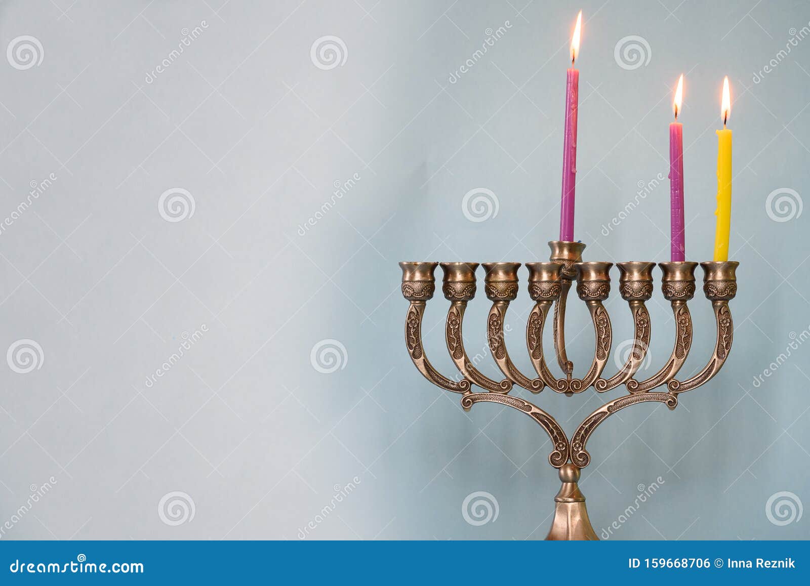 second day of hanukkah with burning hanukkah colorful candles in menorah. copy space for text.