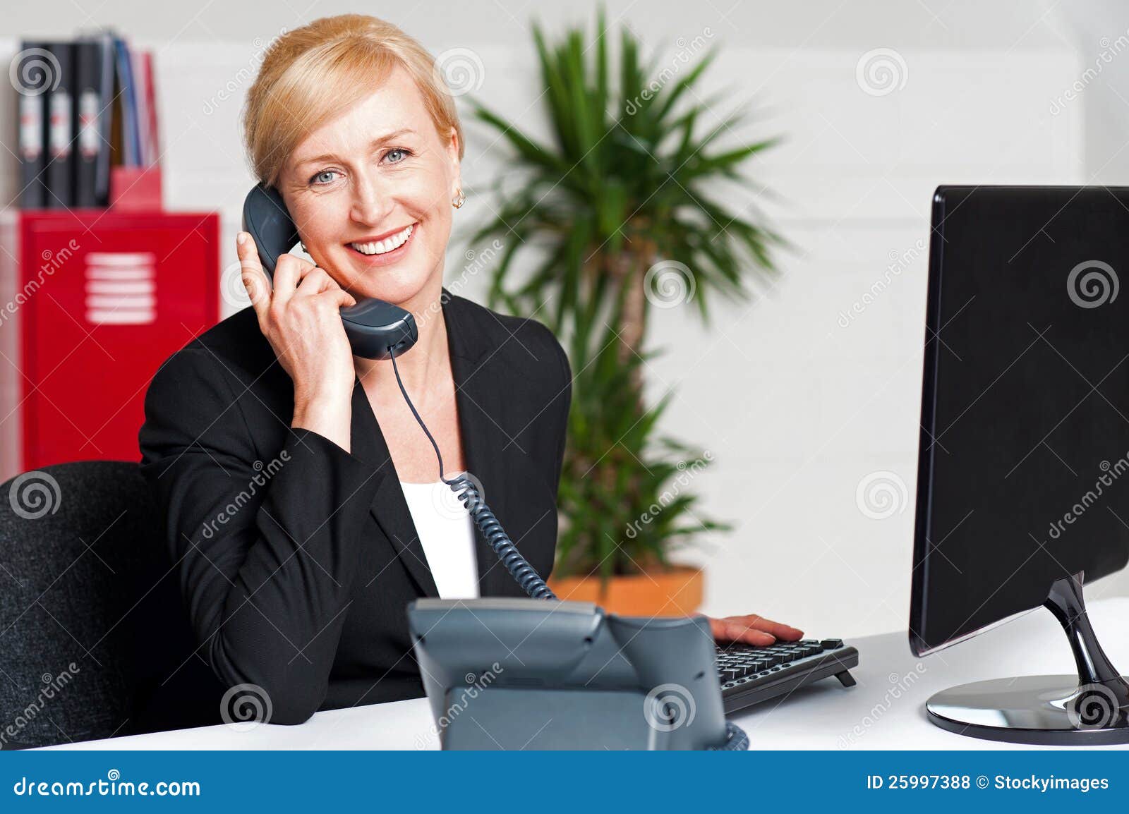 secretary talking on phone with client
