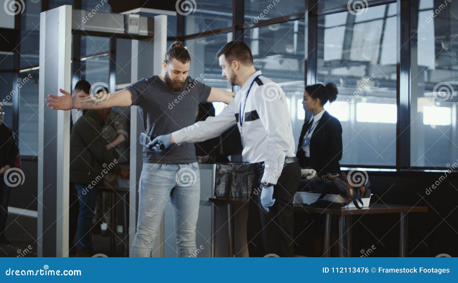 security agent patting down a male passenger