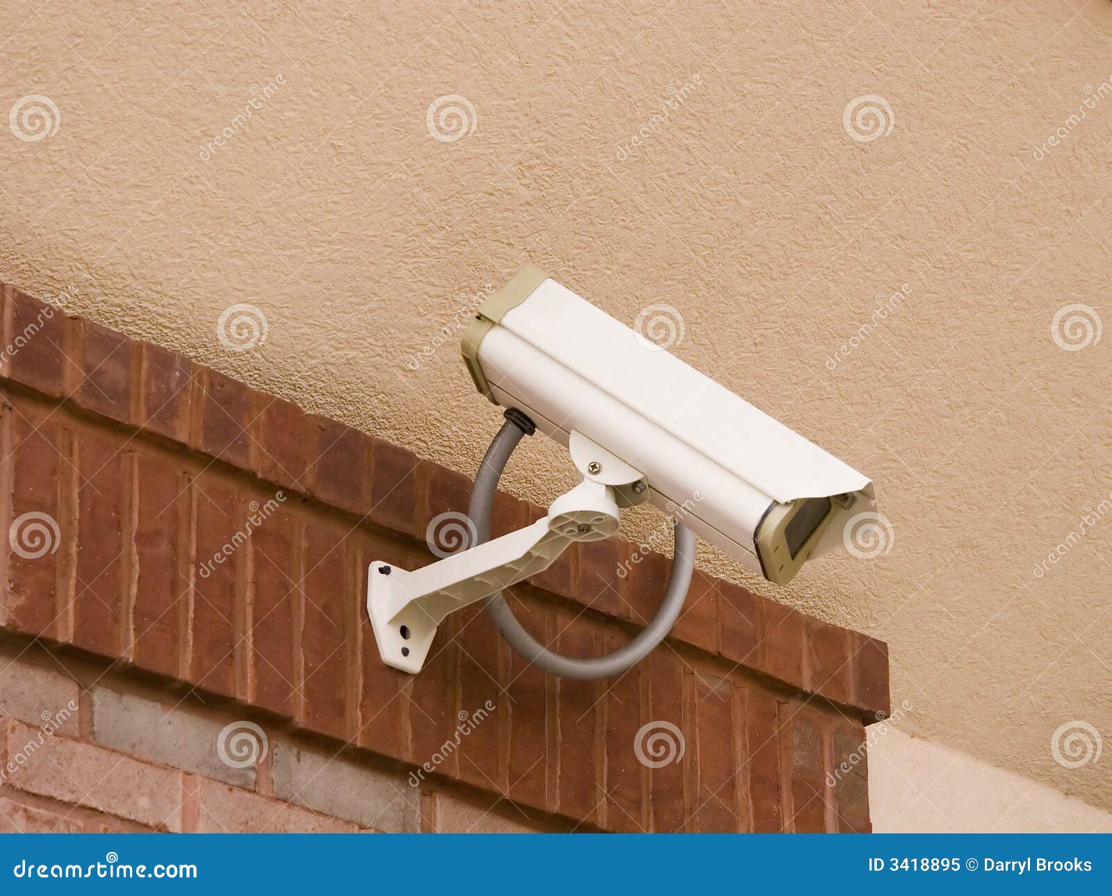 Security Camera on Stucco. A security camera on brick and stucco wall