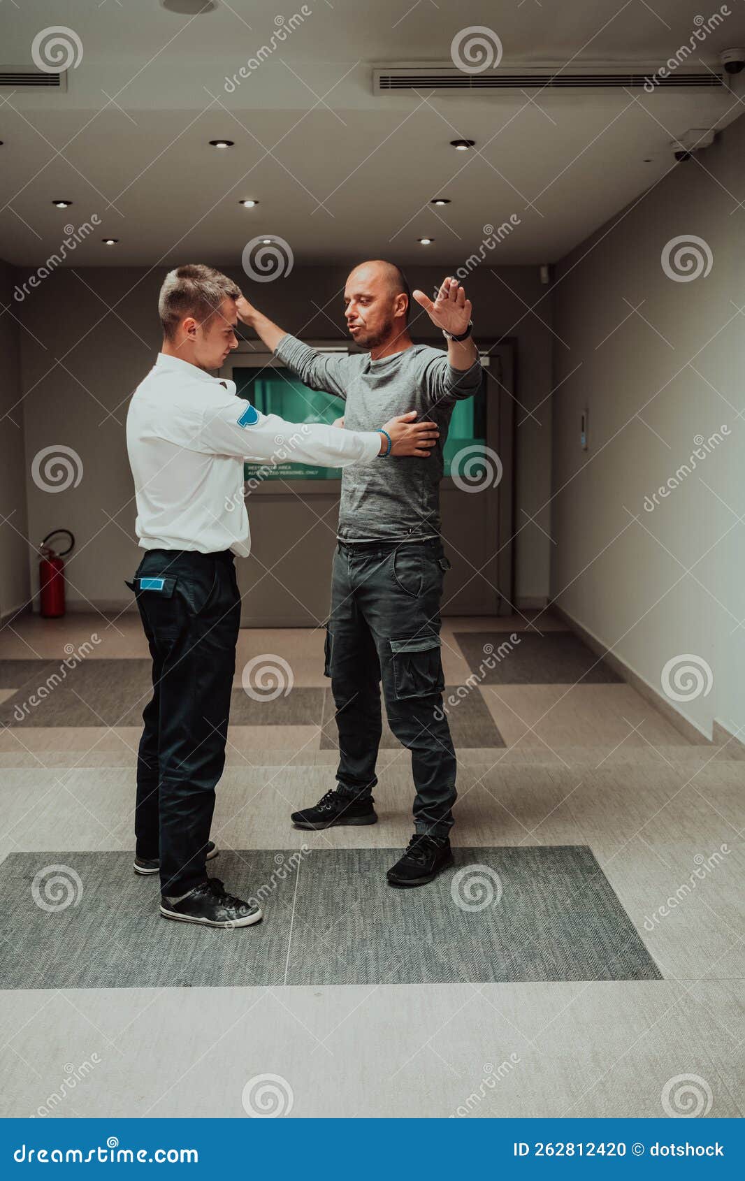 Security Guard Making Body Searching Procedure on Man for Finding