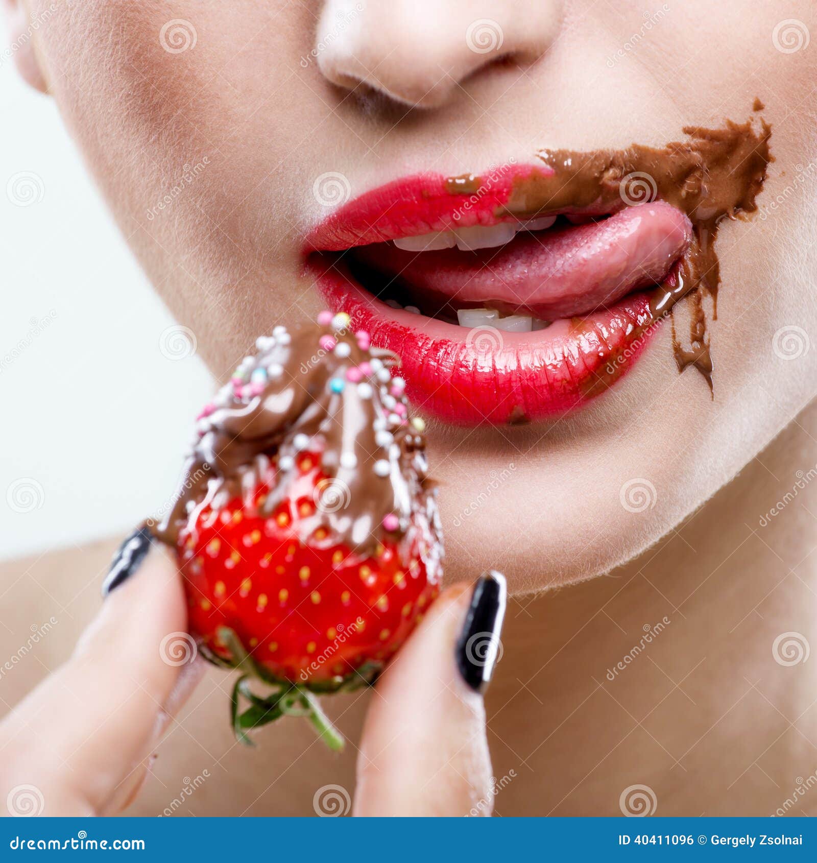 seduction - red female lips with chocolate mouth , holding strawberries
