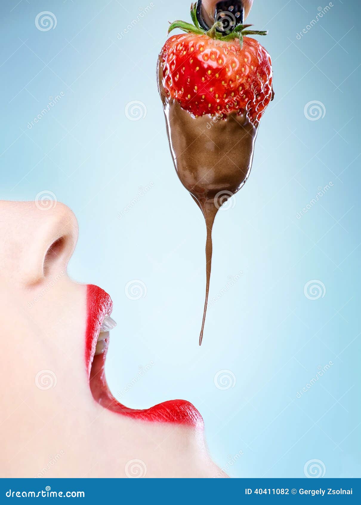 seduction - red female lips eating chocolate strawberries