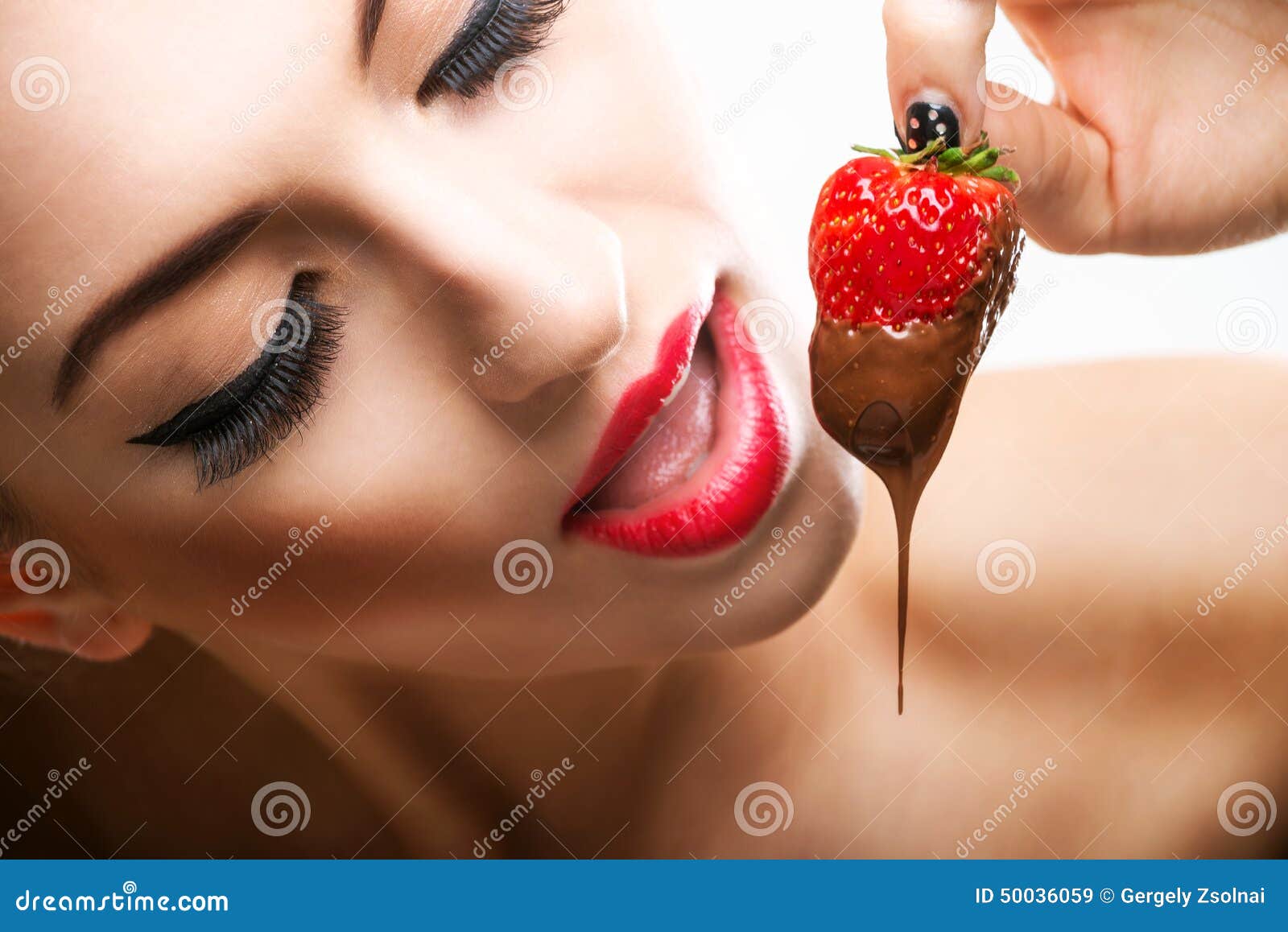 seduction - red female lips eating chocolate strawberries