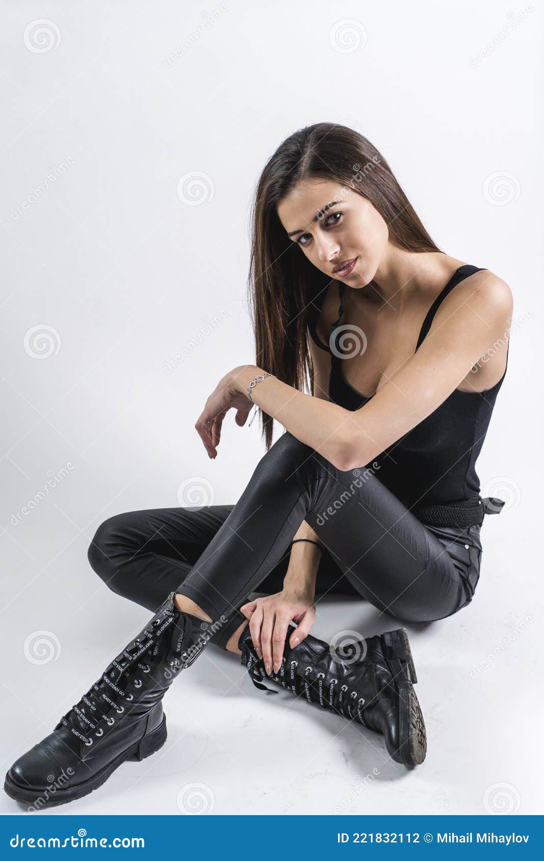 Woman in white pants and black leather boots sitting on white chair photo   Free Teenager Image on Unsplash