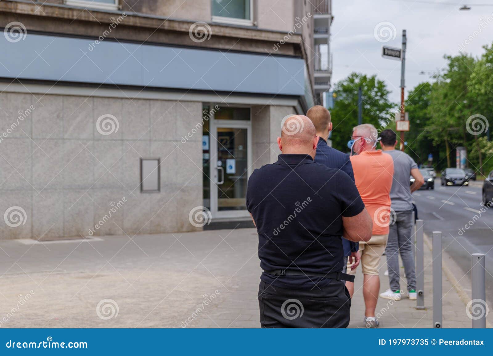 Men with Protective Face Mask Queue and Social Distancing To Enter the ...