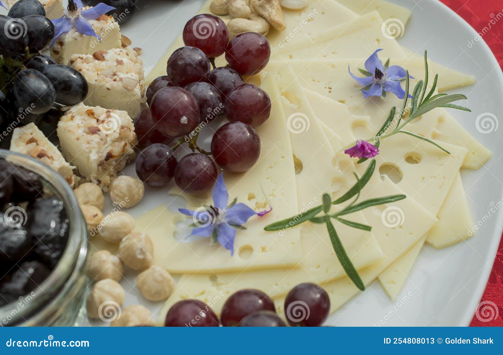 Selection of Cheeses with Grapes and Edible Flowers Stock Image Image