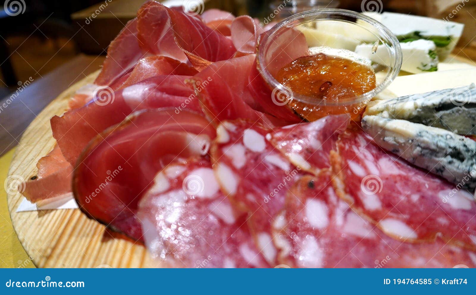 Selection of Cold Cuts and Fresh and Aged Cheeses on a Wooden Cutting Board Stock Image Image