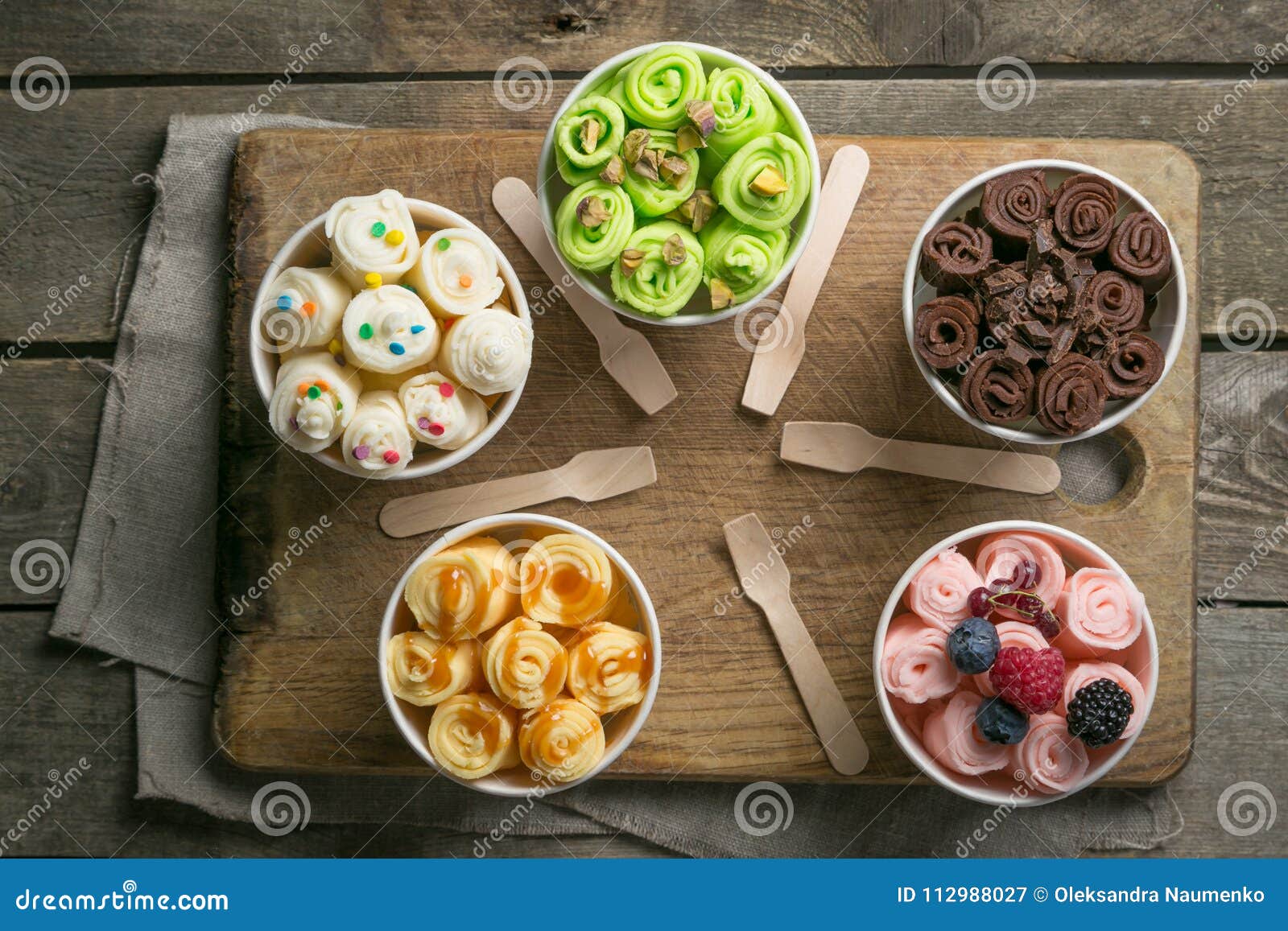 selection of different rolled ice creams in cone cups