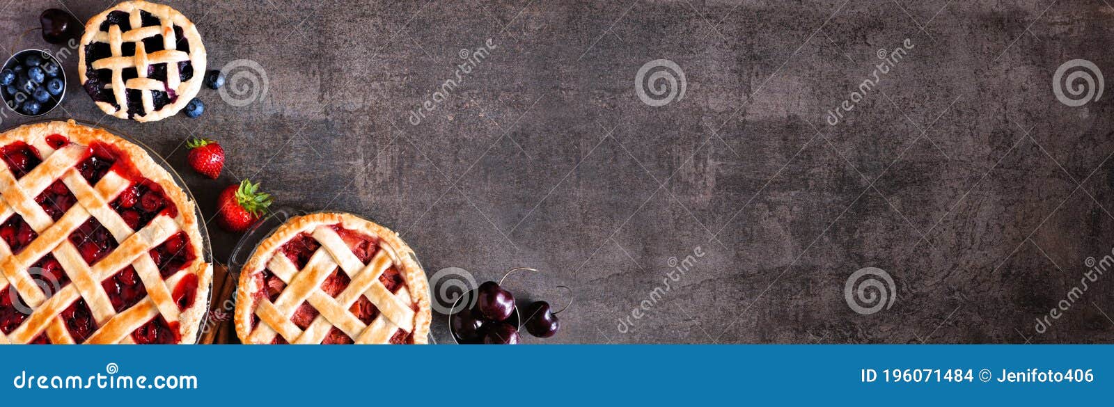 selection of fresh fruit pies. above view corner border over a dark stone background with copy space.