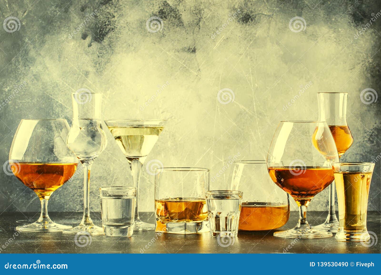 selection of hard strong alcoholic drinks in big glasses and small shot glass in assortent: vodka, cognac, tequila, brandy and