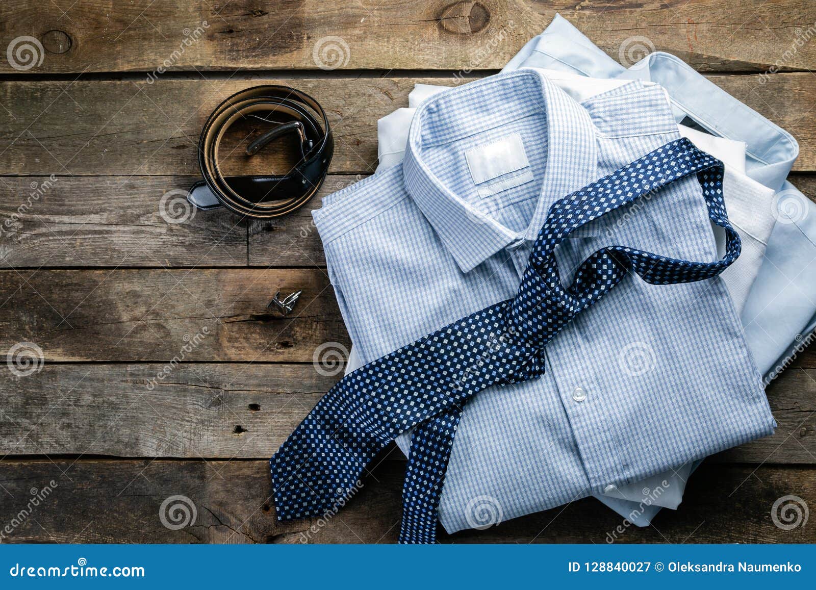 Selection of Male Clothes - Stack of Folded Shirts, Tie, Belt ...