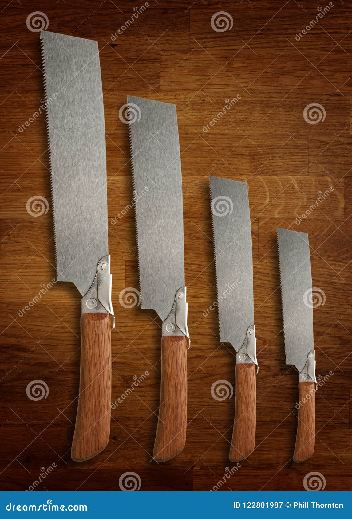 A Selection of Precision Carpentry Hand Saws on a Wooden Board Stock