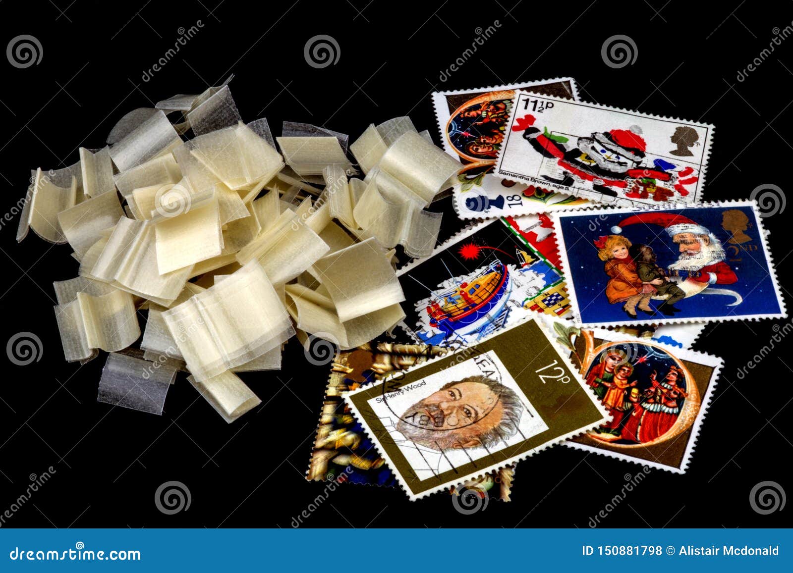 Selection of UK Stamps and Stamp Hinges on Black Editorial Stock Photo