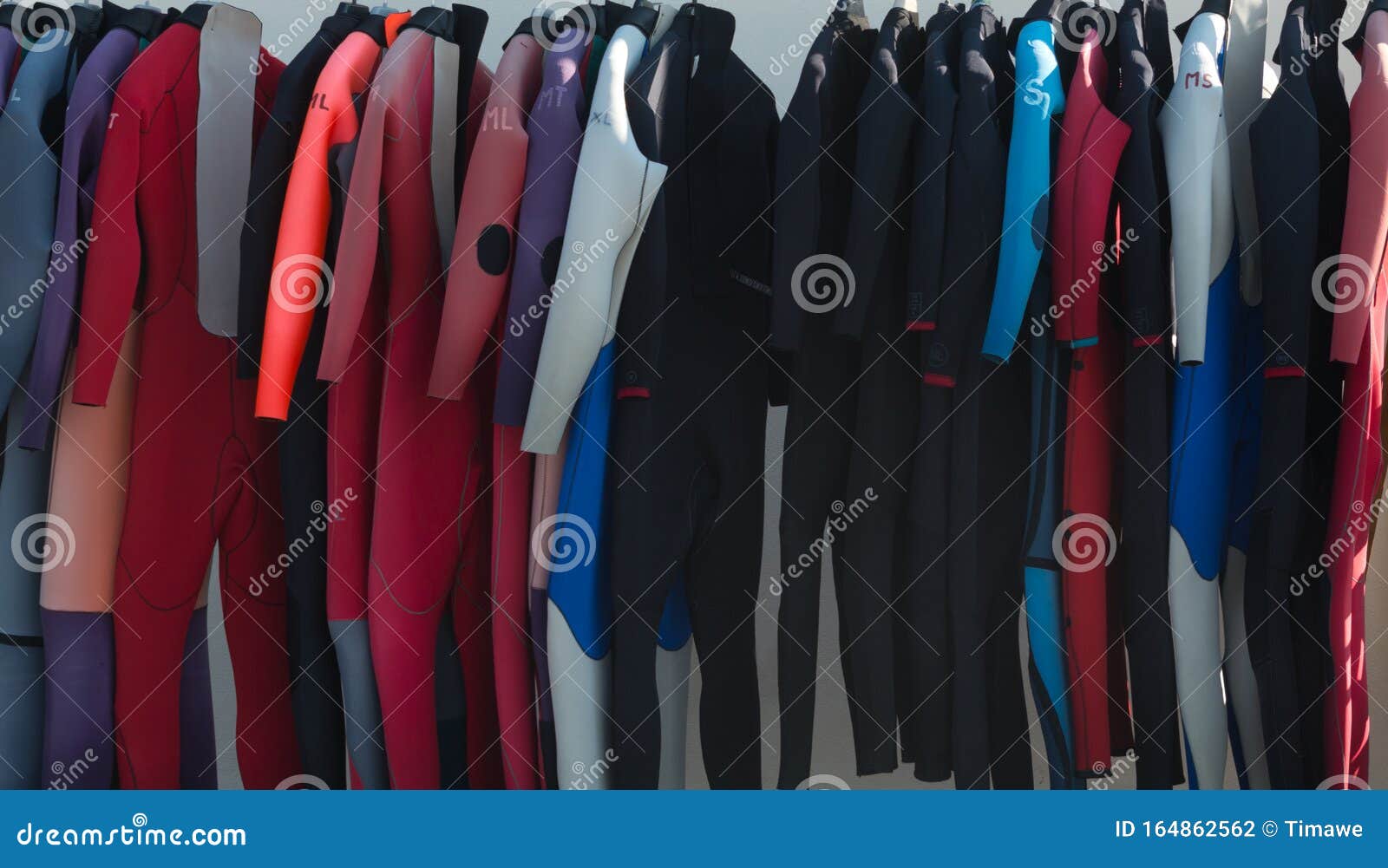 Selection of wetsuits stock photo. Image of piece, drying 164862562