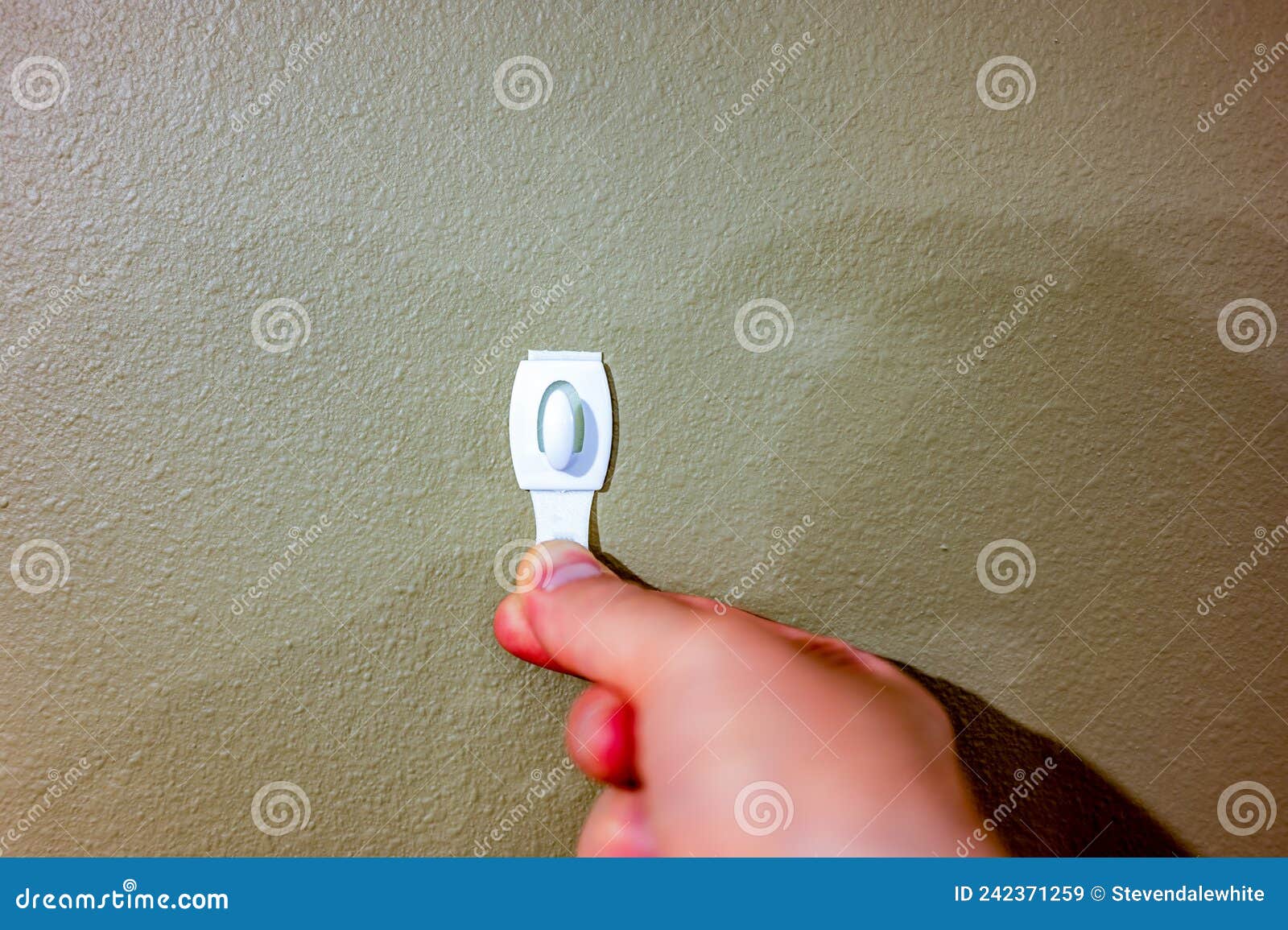 Selective Focus on Adhesive Strip Wall Hanger that Can Be Removed by