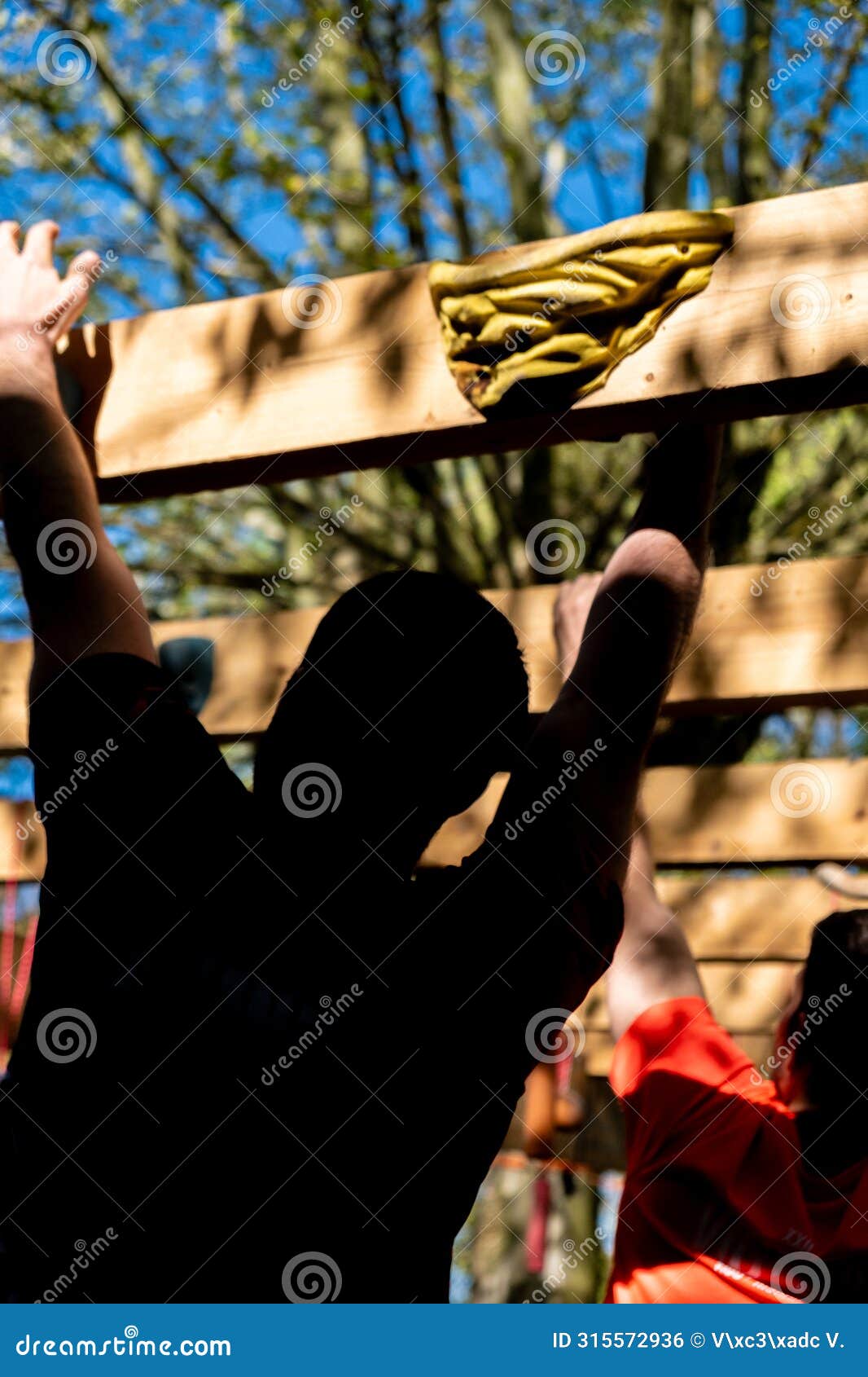 selective focus, athletes hands at a hanging obstacle at an obstacle course race, ocr competition