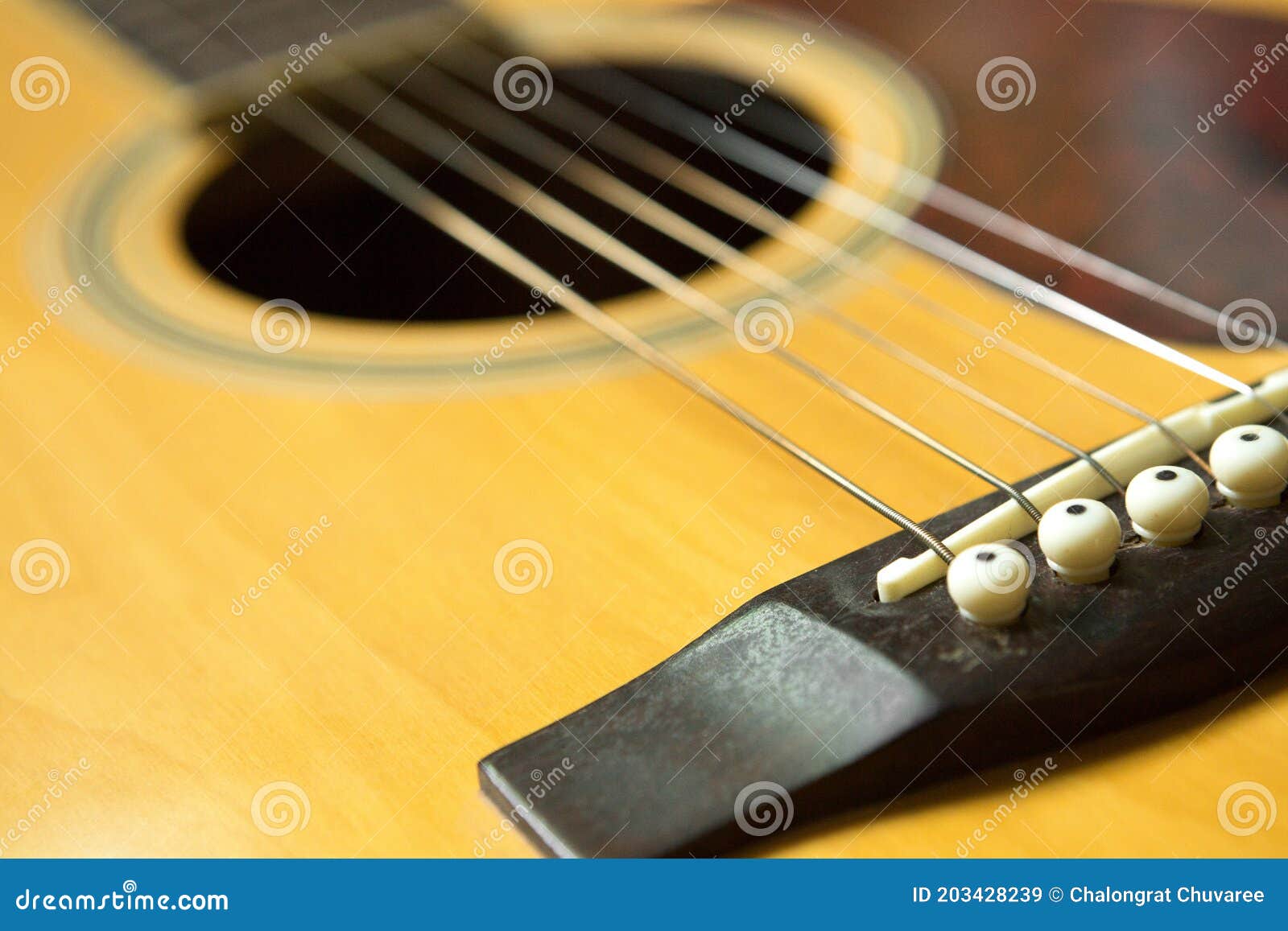 Selective Focus of Bridge on Acoustic Guitar and Copy Space Stock Image