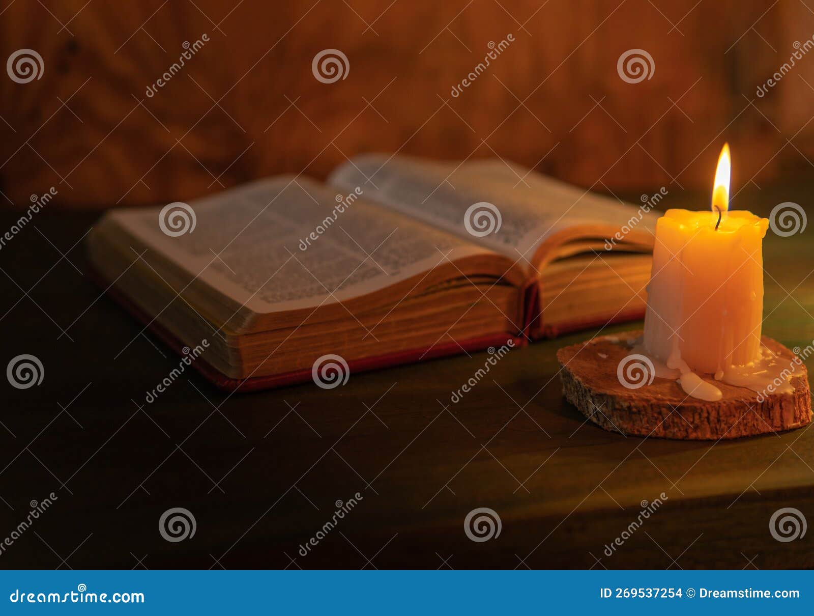 Selective Focus of a Candle Lighting Up on a Bible. Religious Message