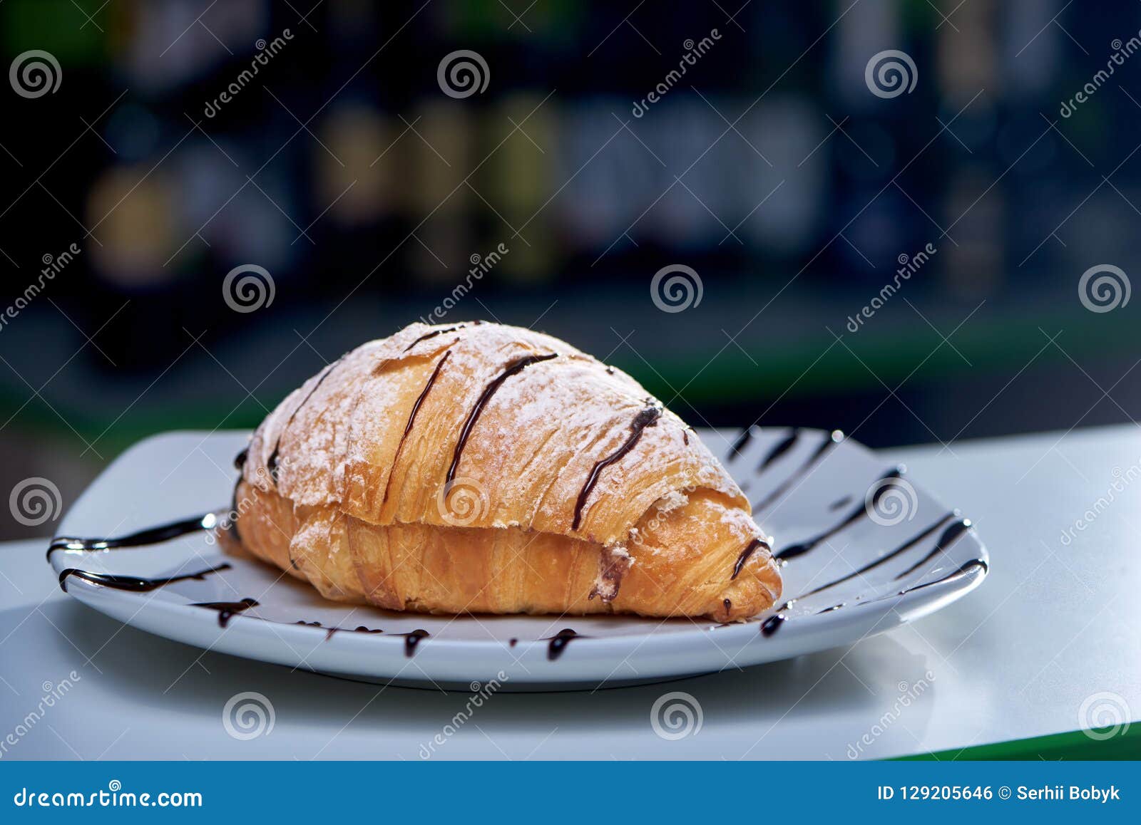 selective focus of delicious croissant poured with chocolate