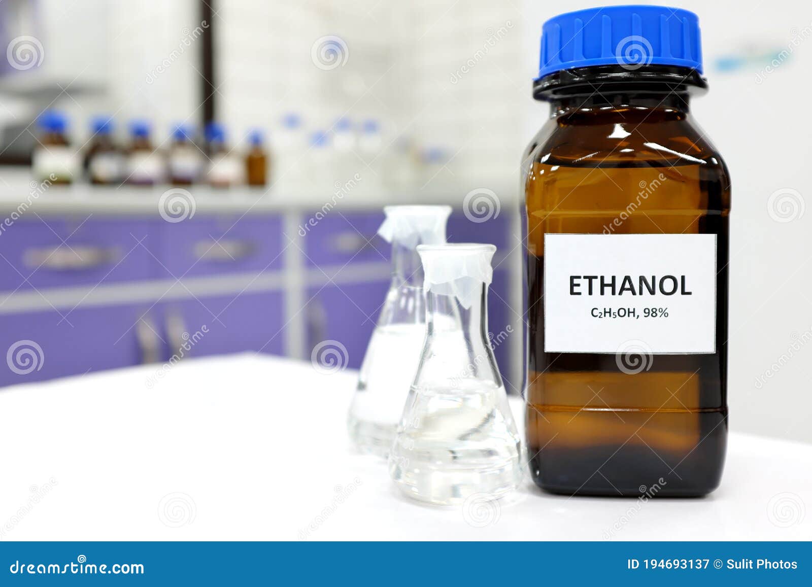 selective focus of ethanol or ethyl alcohol in brown glass bottle inside a laboratory.