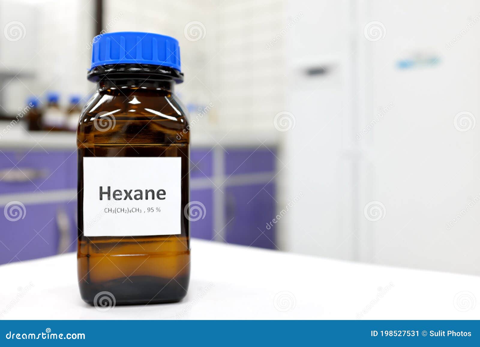 Selective Focus of Hexane Liquid Chemical Compound in Dark Glass Bottle