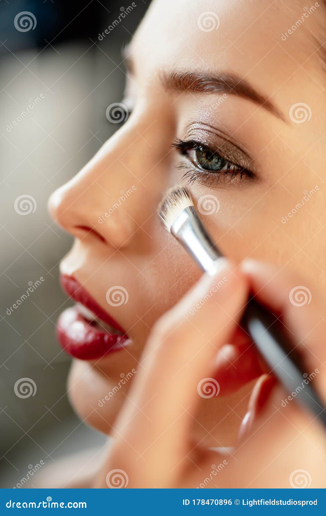 Focus of Makeup Artist Applying Concealer on Model Stock Photo Image