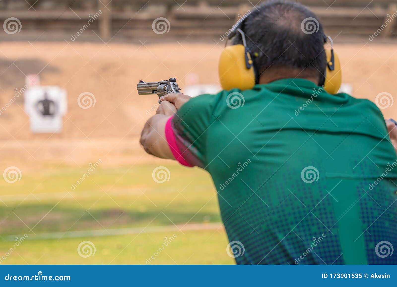 Selective Focus of Man Holding and Fire Hand Gun in Gun Shooting