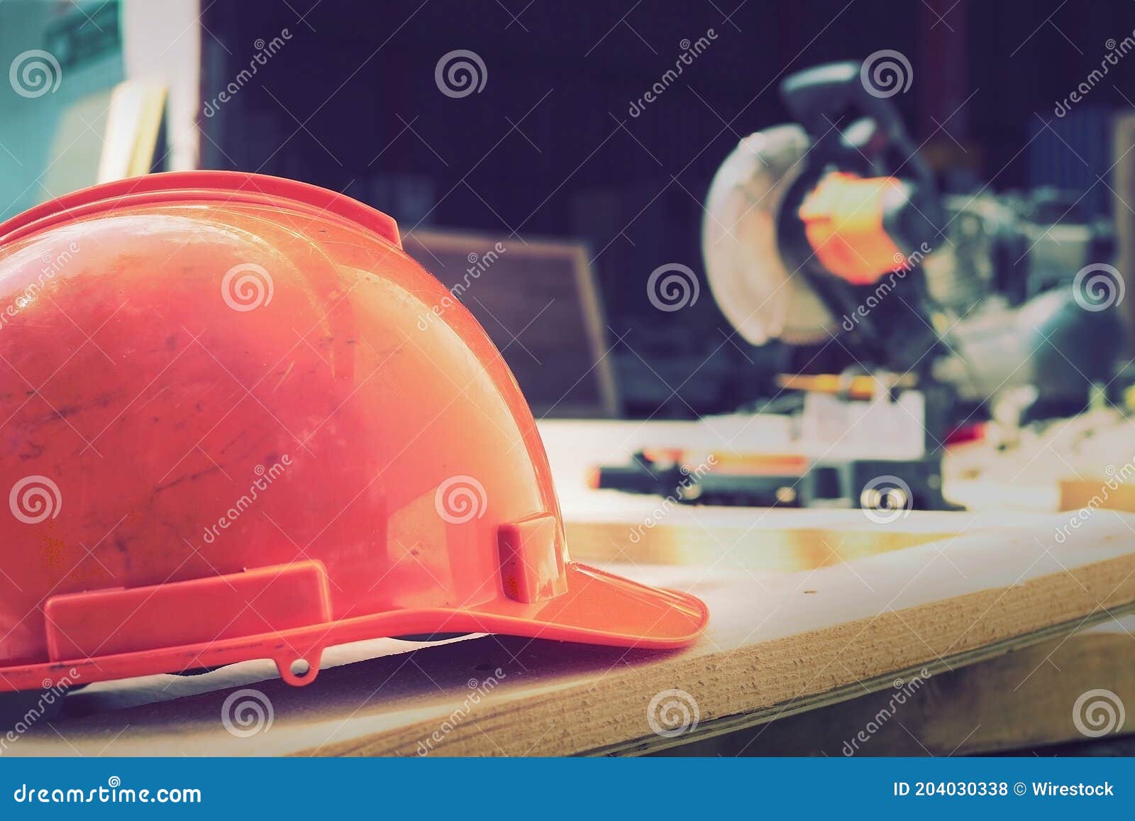 Selective Focus of a Red Construction Hat on Blurred Background of Types of Equipment Stock