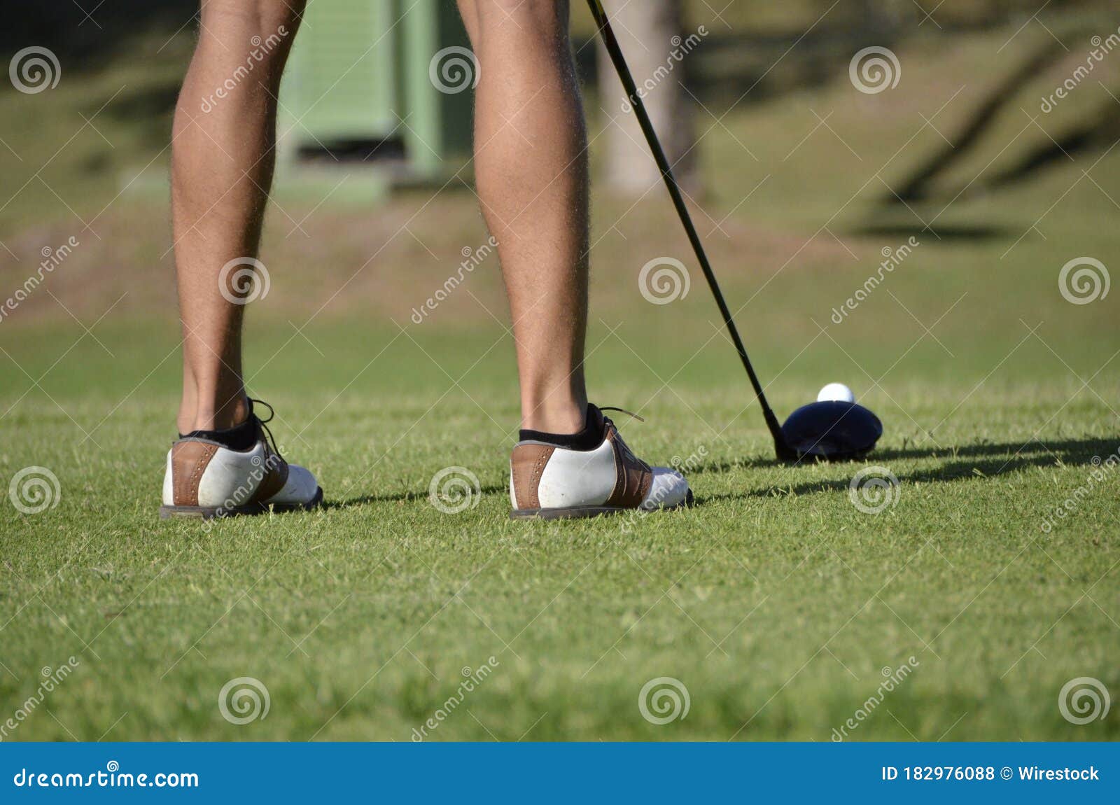 Selective Focus Shot of a Golfer S Feet with a Golf Club and Ball Under