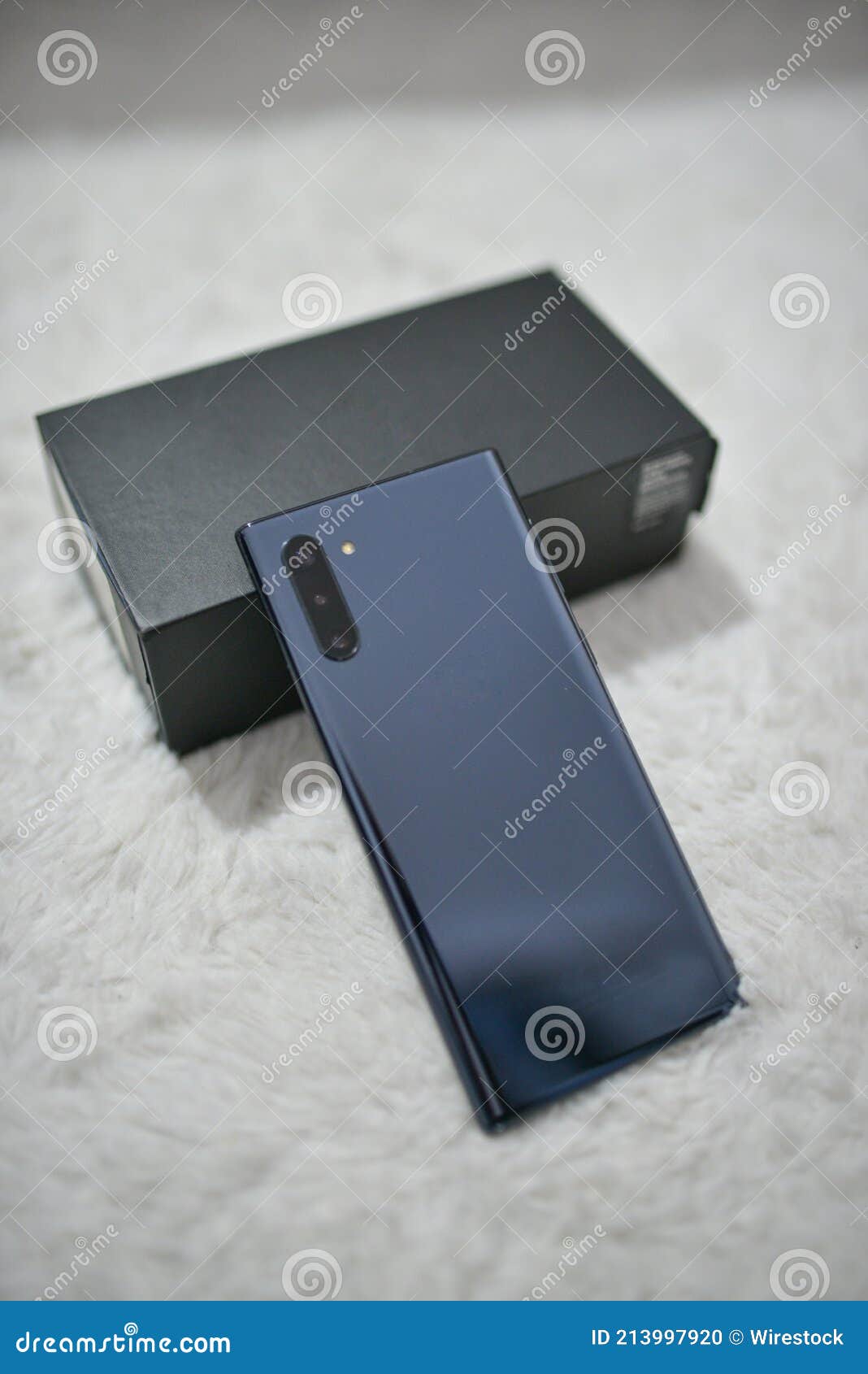 Selective Focus Shot of a Smartphone with a Black Box on the White Soft