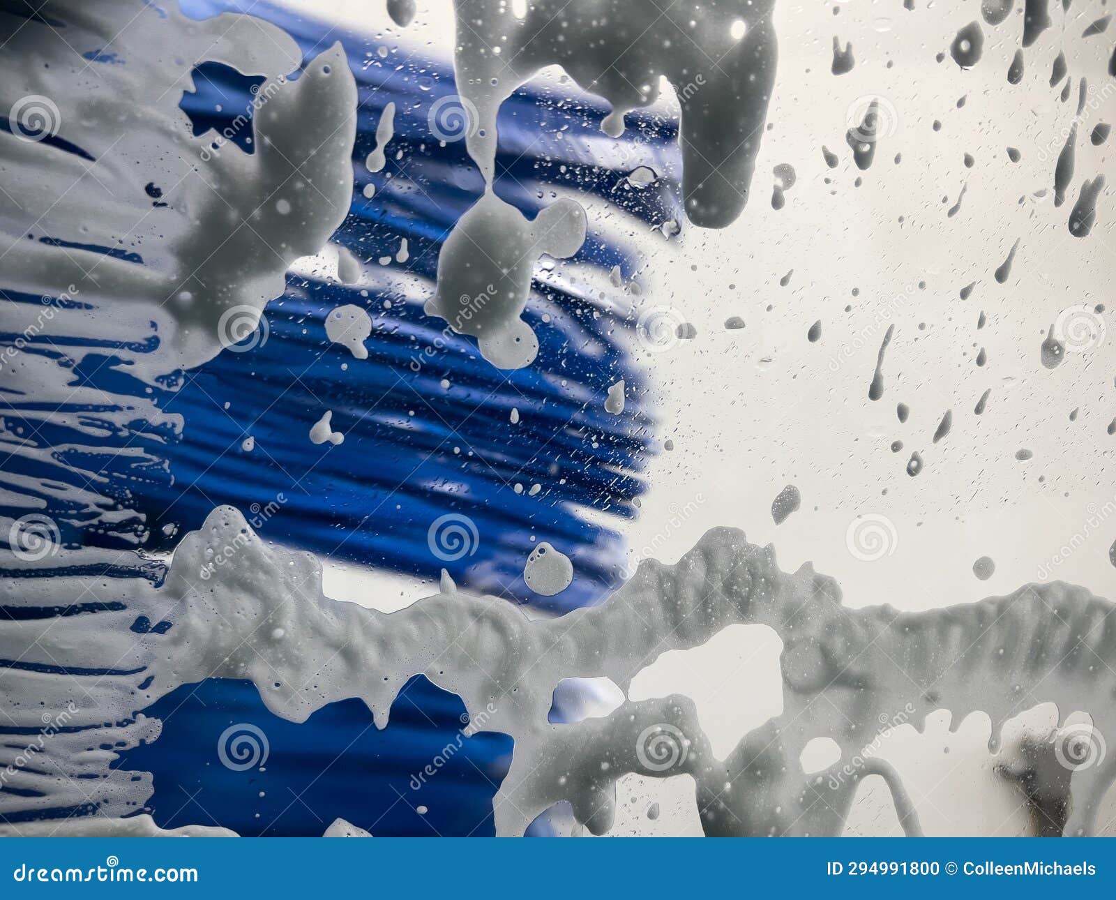 Selective Focus on Soap Suds on the Windshield of a Car during an