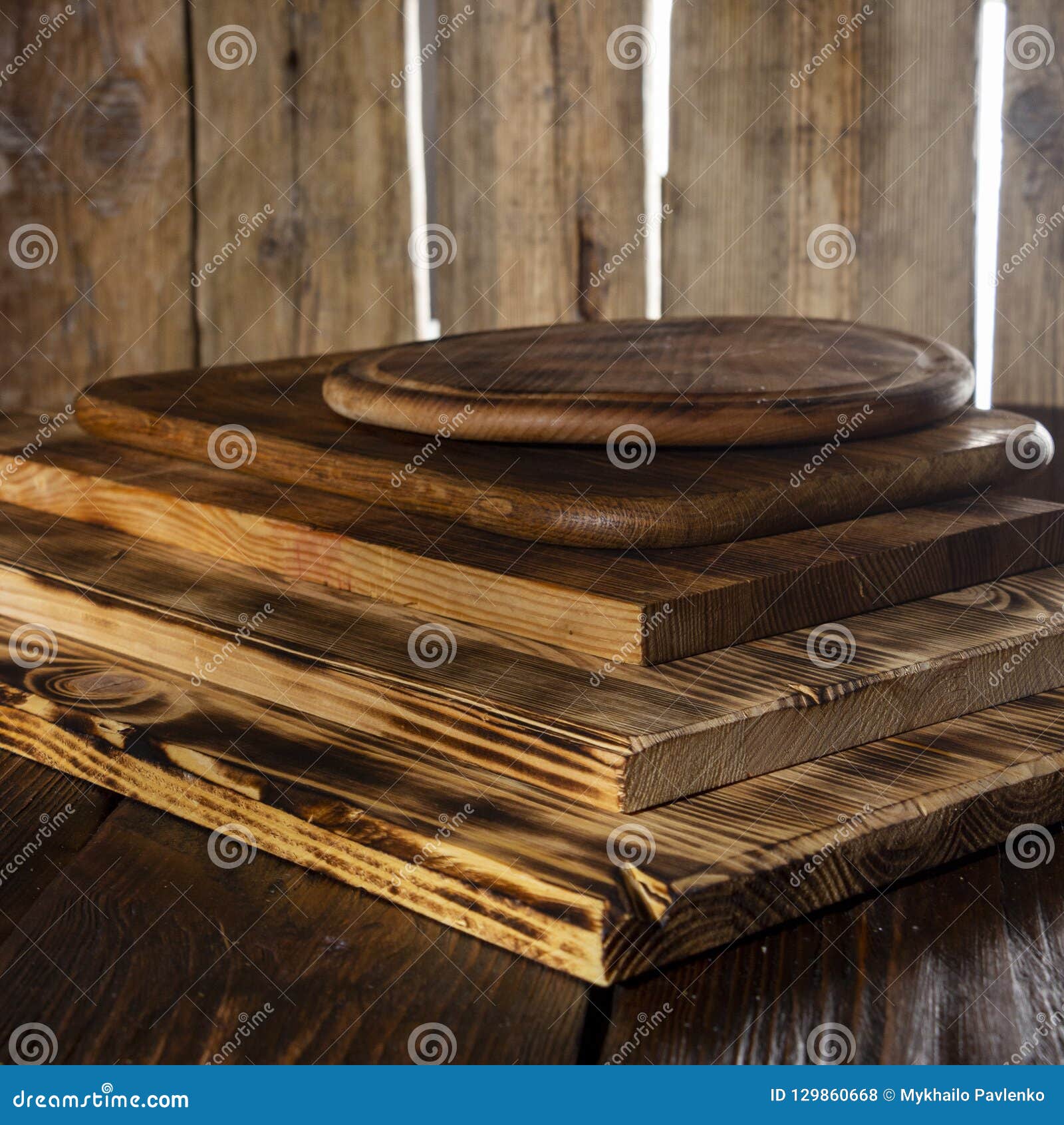 Selective Focus of Stack of Different Wooden Cutting Boards on Wooden