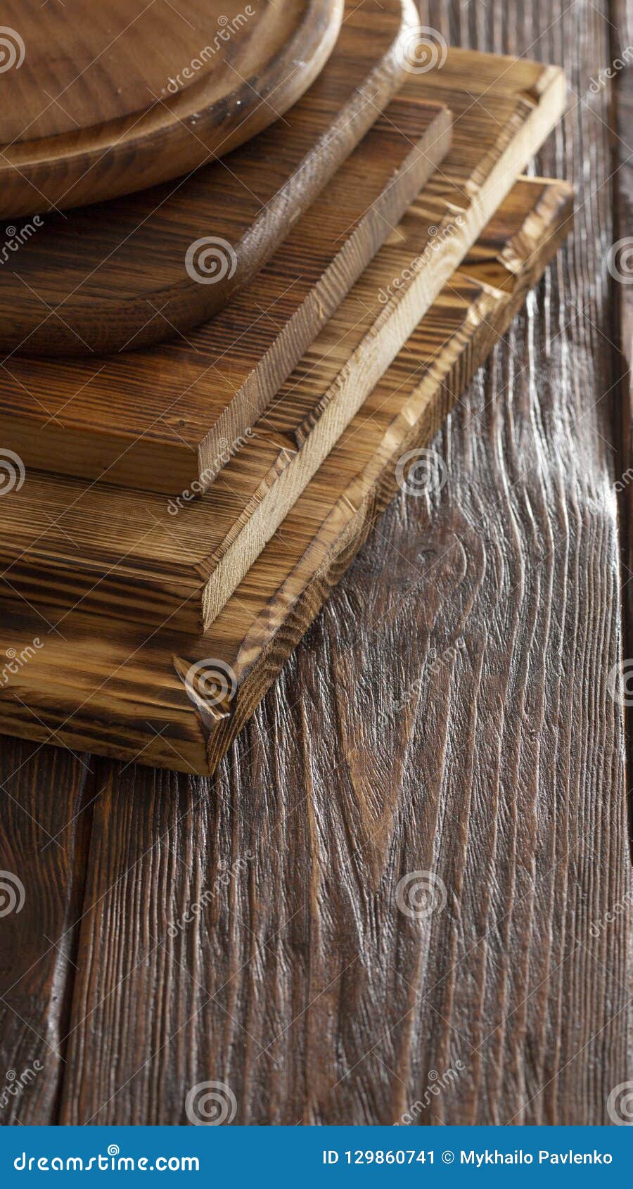 Selective Focus of Stack of Different Wooden Cutting Boards on Wooden