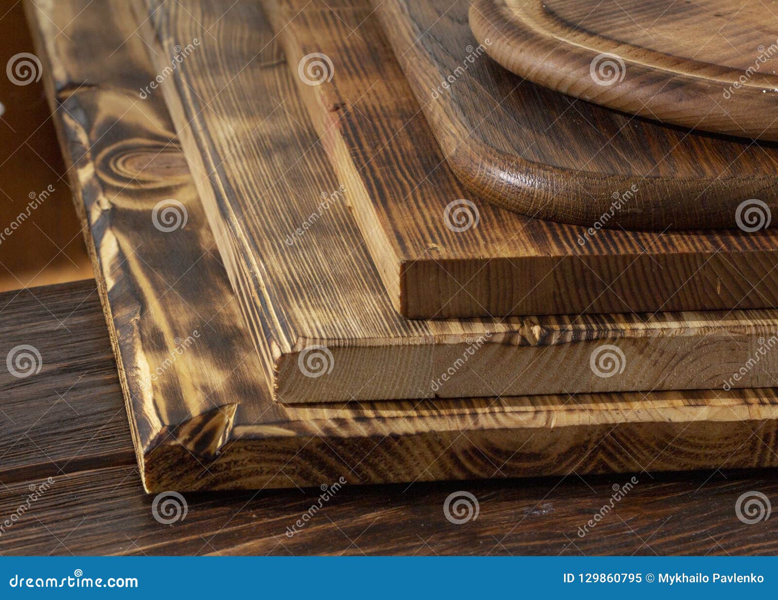 Selective Focus of Stack of Different Wooden Cutting Boards on Wooden