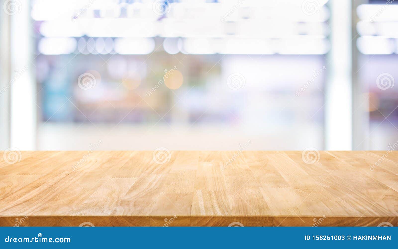 selective focus of wood table top on blur product shelf in supermarket background