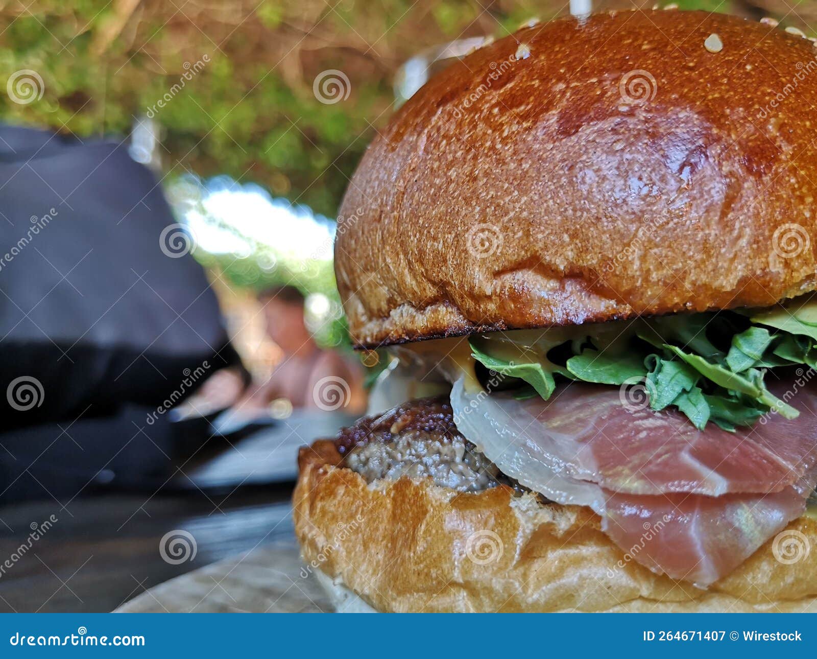 Selective Shot of a Yummy Burger with Patty Ground Beef Meat Ham and Lettuce Inside Buns Stock