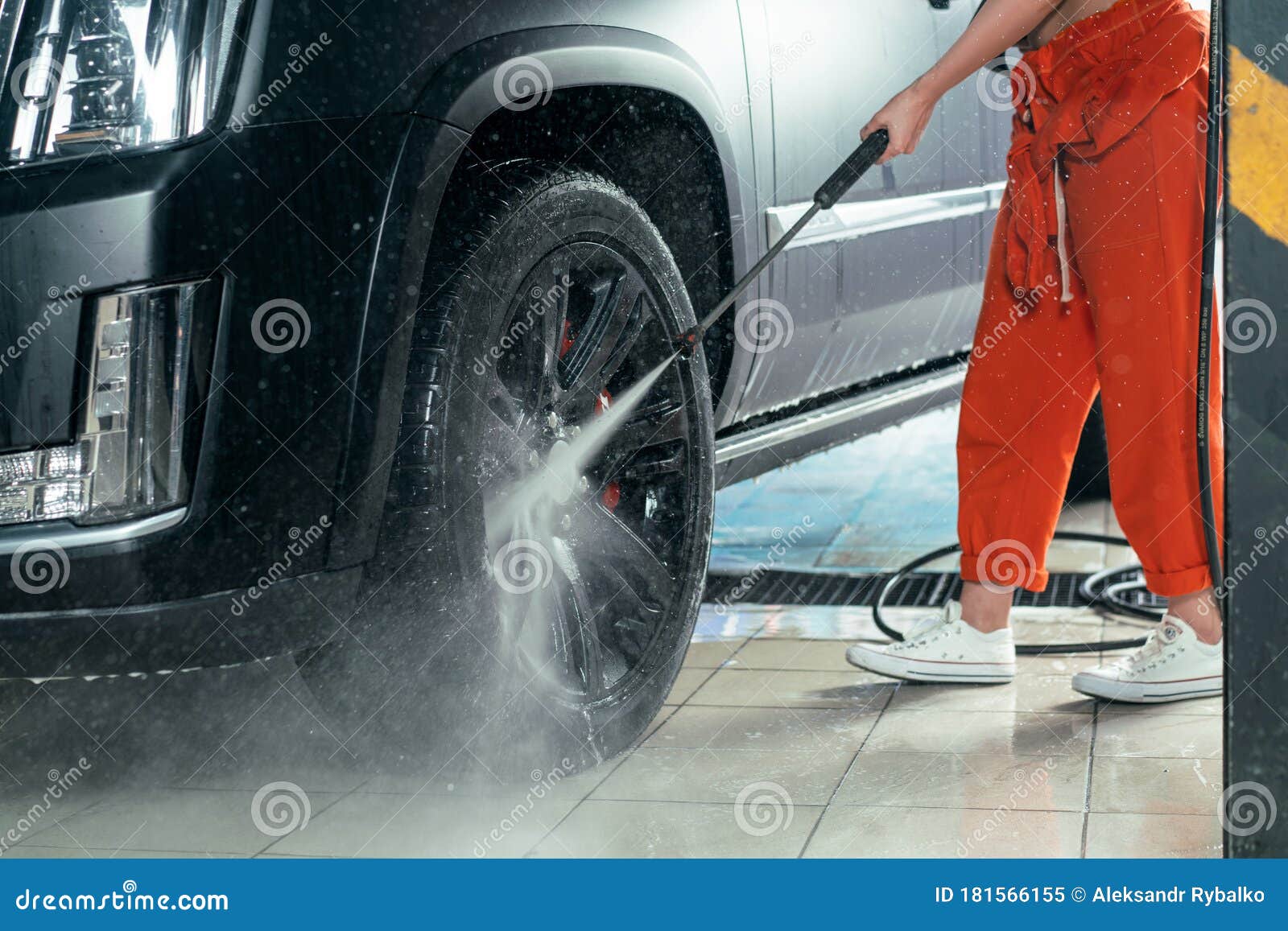 Self Car Washing. Cleaning Wheels Using High Pressure Water. Stock