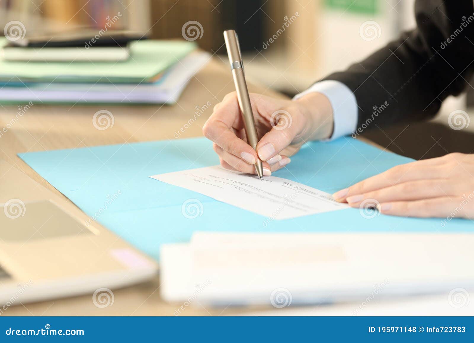 self employed hands signing bank check at homeoffice