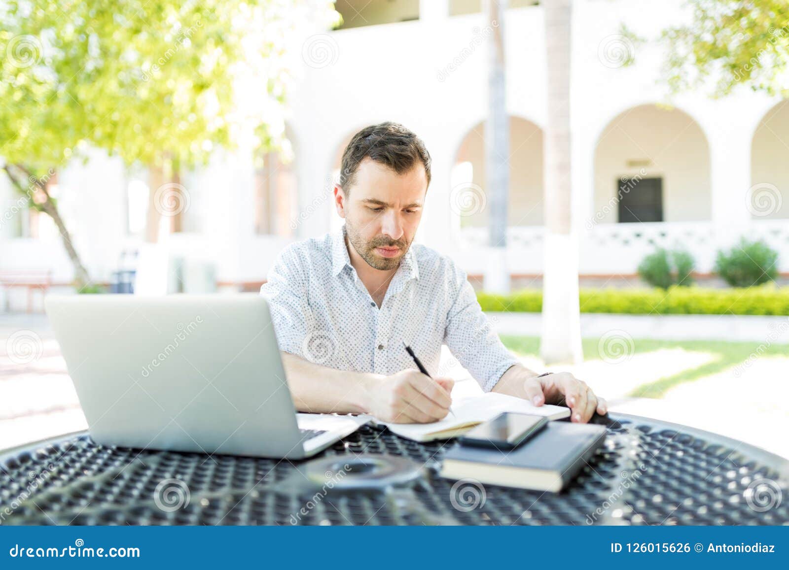 self-employed man preparing schedule in garden