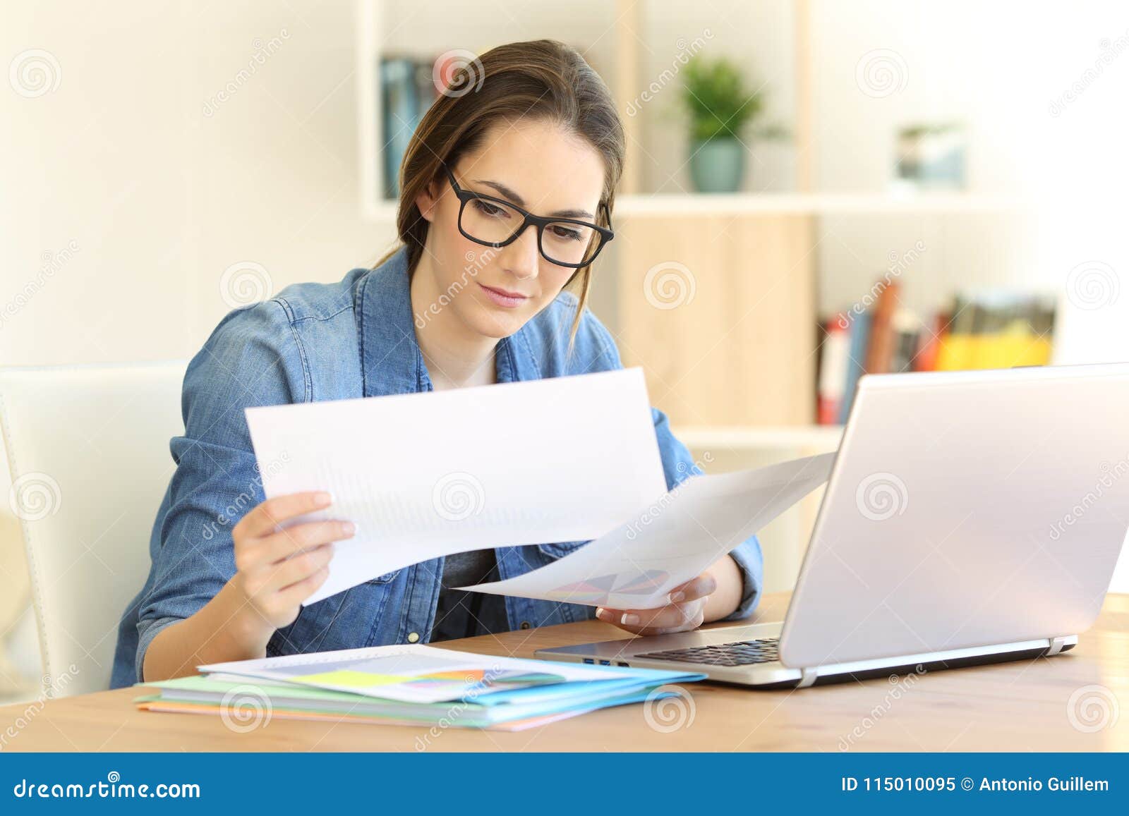 self employed working comparing documents at home