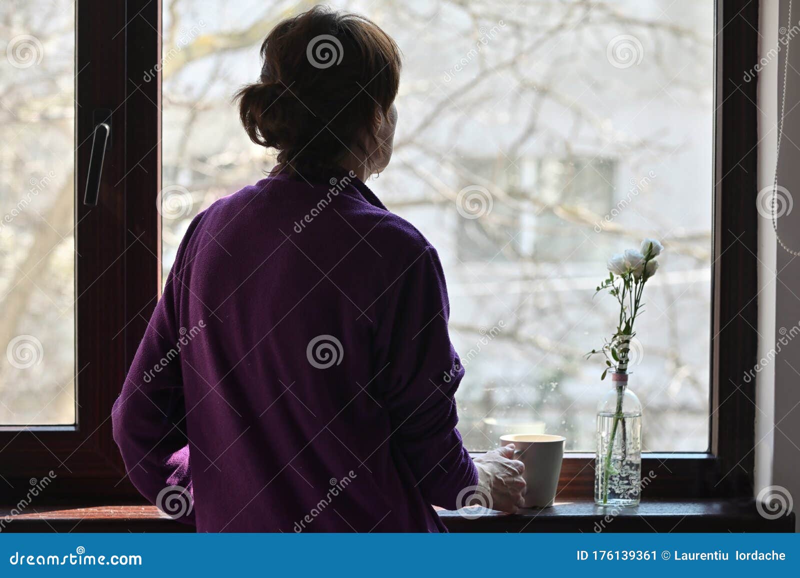 a self-isolate woman or quarantine looking out