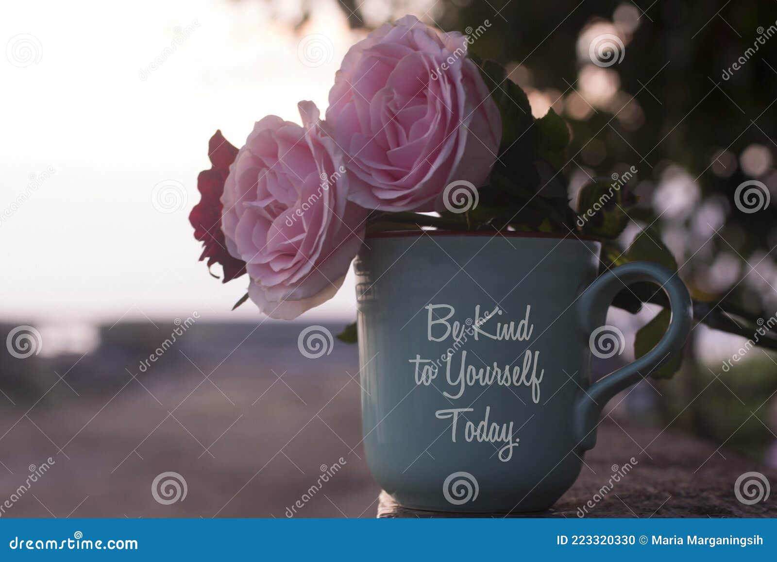 self love and care inspirational quote on coffee cup - be kind to  yourself today. with pink roses and coffee cup vase decoration.