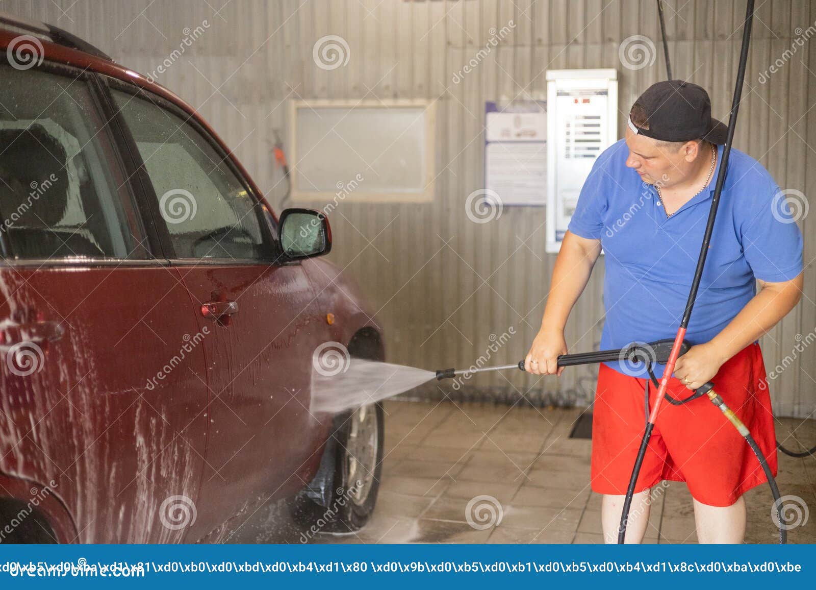 Premium Photo  Selfservice car wash a man washes off the foam