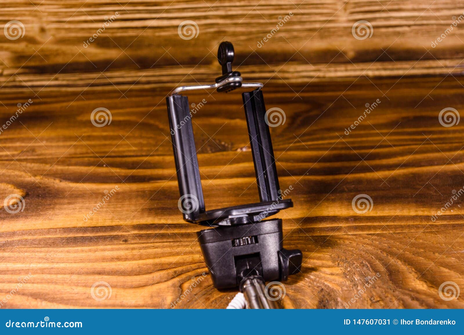 Selfie Stick with Adjustable Clamp on a Wooden Table Stock Image