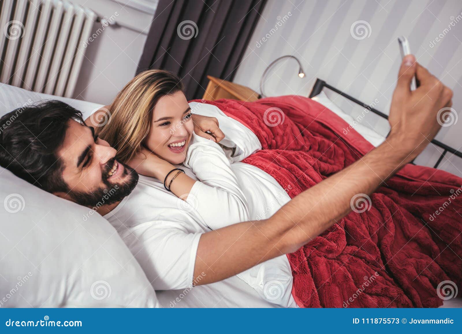 couple bed selfie